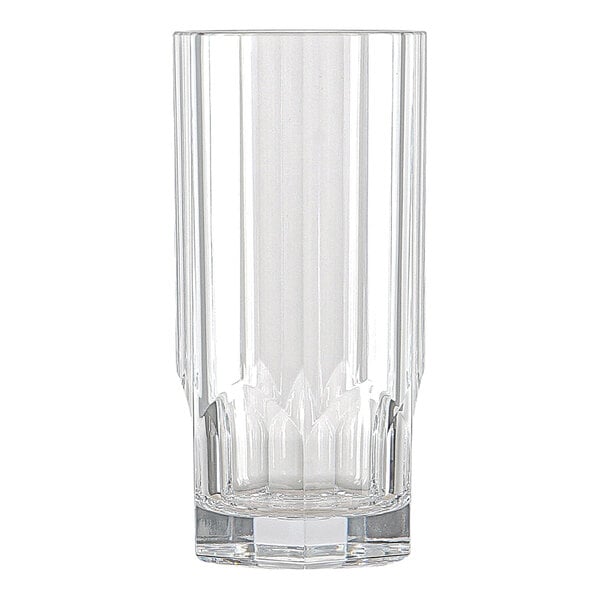 A clear, tall drinking glass with vertical faceted lines and a thick base.