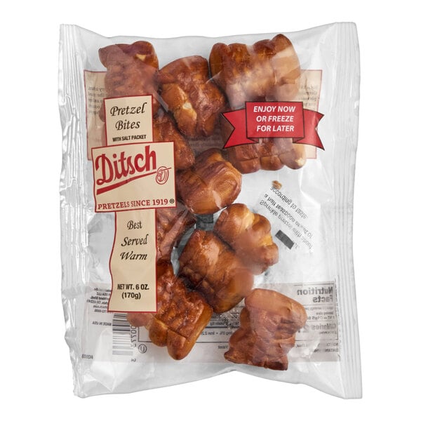 A clear plastic bag containing several brown pretzel bites with visible labeling and branding on the packaging.