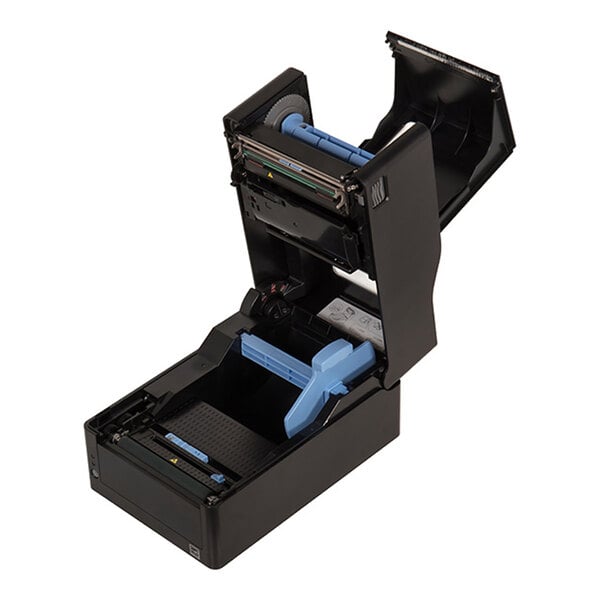 A black device with its top cover open, revealing internal components including rollers and blue plastic parts, likely for loading media or labels.