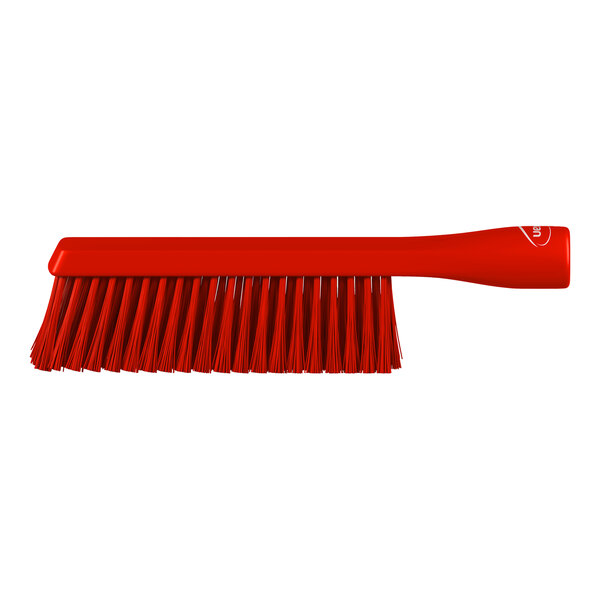 A red brush with a long handle and densely packed bristles, shown against a white background.
