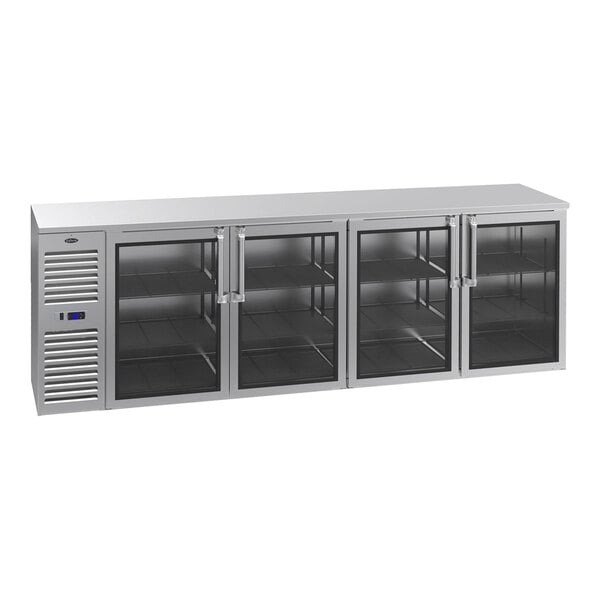 A stainless steel counter-height refrigerator with four glass doors and a left-side compressor unit.