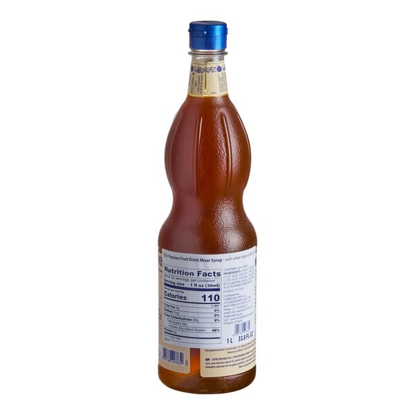 A tall, curvy bottle filled with amber-colored liquid, featuring a blue cap and a nutrition facts label on the back.