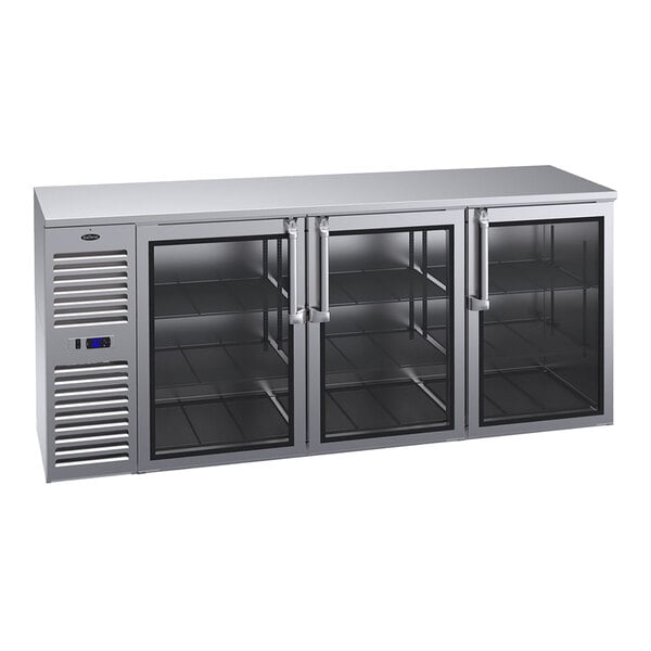 A stainless steel counter-height refrigerator with three glass doors and a left-side compressor unit.