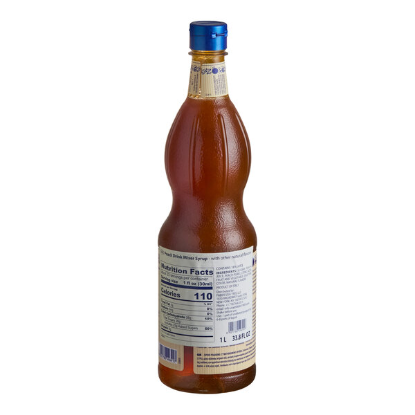A tall, curvy bottle filled with amber-colored liquid, featuring a blue cap and a nutrition facts label on the back.