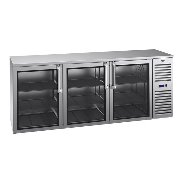 A stainless steel counter-height refrigerator with three glass doors, interior shelving, and a right-side compressor vent.