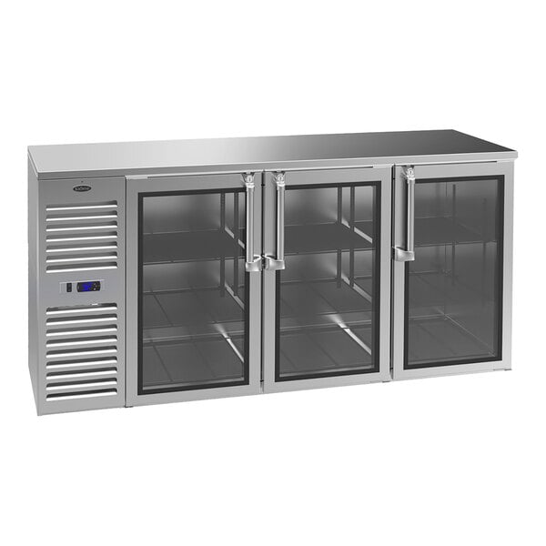 A stainless steel counter-height refrigerator with three glass doors, interior shelving, and a left-side compressor unit.