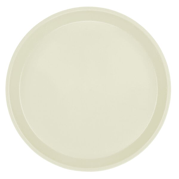 A round white Cambro fiberglass tray with a rim.