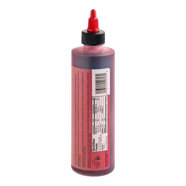 A plastic squeeze bottle filled with red liquid, featuring a red nozzle cap and a label with nutritional information and a barcode.