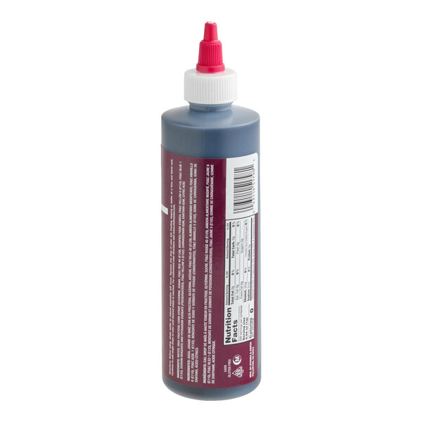 A plastic squeeze bottle with a red and white twist cap, containing a dark liquid and labeled with nutritional information and a barcode.
