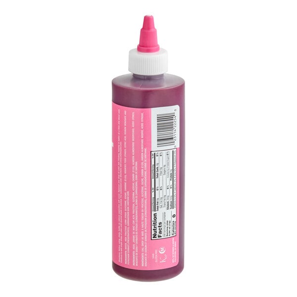 A plastic squeeze bottle with a pink label and a pink-tipped nozzle, containing a purple liquid, shown with nutrition facts and barcode visible.
