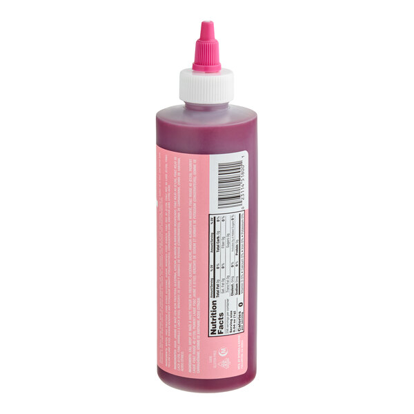 A plastic squeeze bottle with a pink liquid and a pink twist cap, featuring a nutrition facts label and barcode on the side.