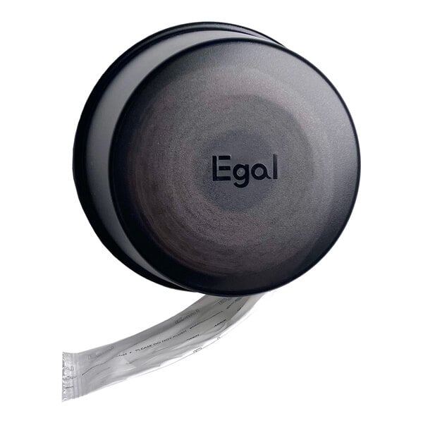 A black circular wall-mounted dispenser with the word 'Egal' on the front and a strip of individually wrapped items being dispensed from the bottom.