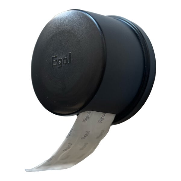 A black cylindrical wall-mounted dispenser with a roll of sanitary napkin pads partially dispensed.