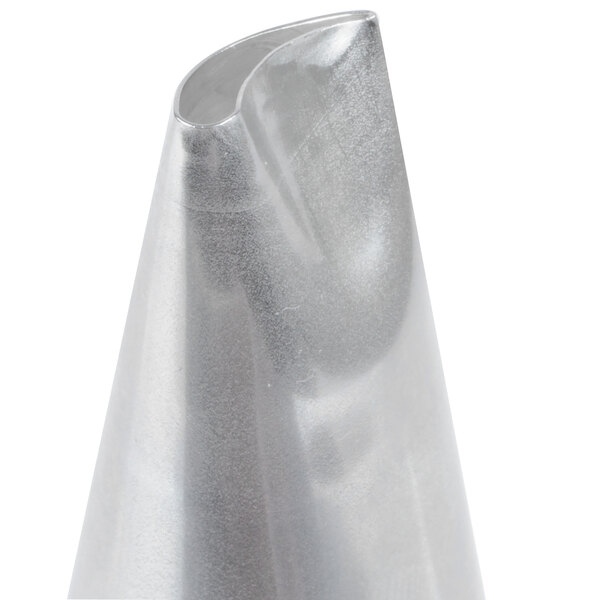 A close-up of a metallic piping tip with a curved, slanted opening.