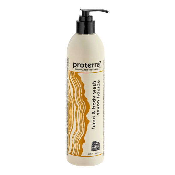 A tall, cylindrical bottle with a pump dispenser, featuring a cream-colored label with brown abstract lines and text indicating it is a hand and body wash.