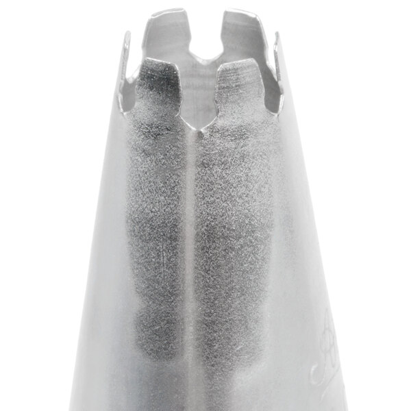 A close-up view of a metal piping tip with a notched, flower-shaped opening.