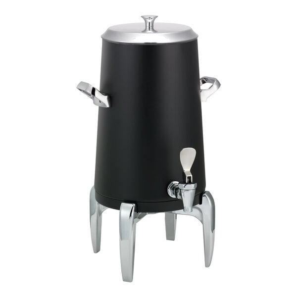 A black, stainless steel, vacuum-insulated beverage urn with a flat lid, side handles, a spigot, and four metallic legs.
