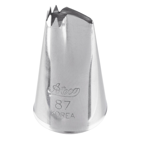 A metal piping tip with a jagged, ruffled opening and engraved text on the side.
