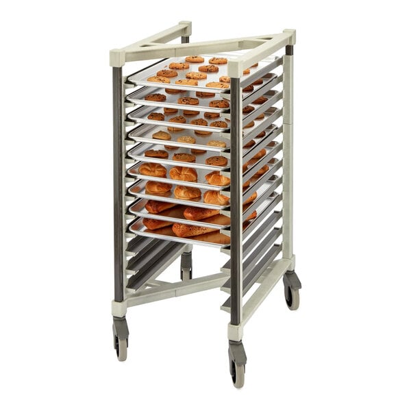 A rolling rack with multiple shelves holding trays of baked goods such as cookies and rolls.