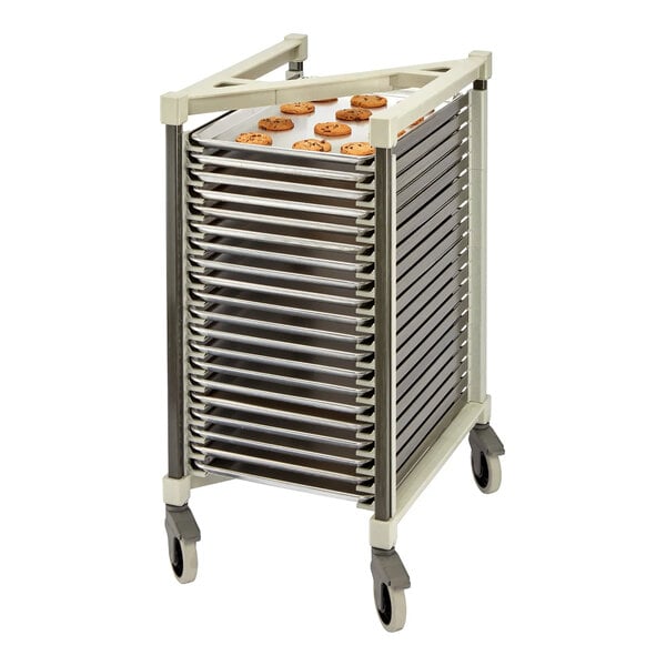 A mobile rack with multiple horizontal slots holding metal trays, one of which has cookies on it.