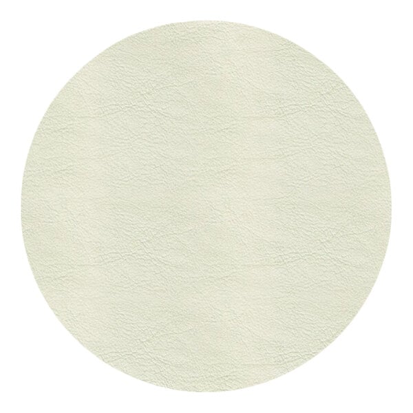 A close-up view of a light beige, leather-like textured surface in a circular shape.