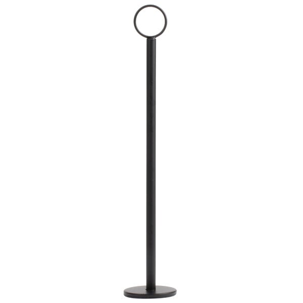 A tall, slender black stand with a circular base and a ring at the top, likely used for holding cards or menus.