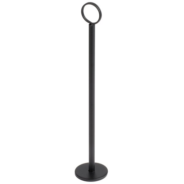 A tall, slender black stand with a circular base and a ring at the top, likely used for holding cards or menus.