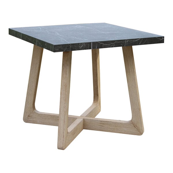 A square table with a dark stone-like top and light wood legs arranged in a geometric cross pattern.