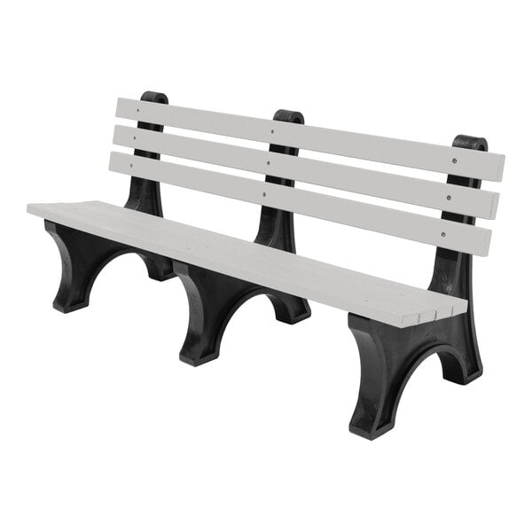 A bench with gray horizontal slats for the seat and backrest, supported by black arched legs.