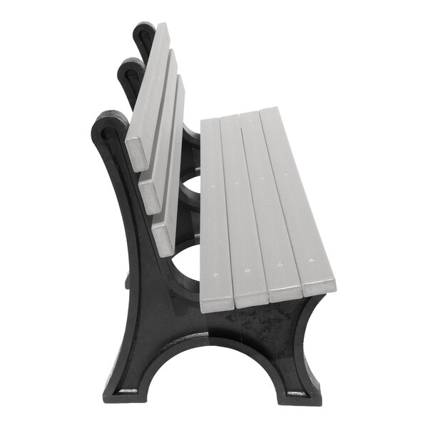 A side view of a bench with gray slats and black curved supports, photographed on a white background.