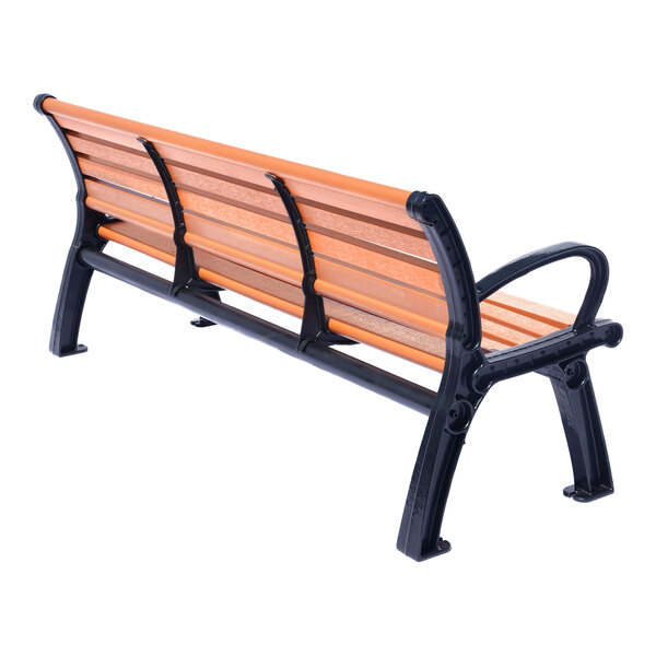 A bench with light brown slats and black metal legs and armrests, viewed from the back at an angle.