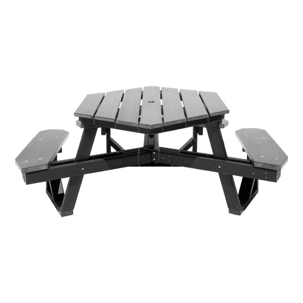 A gray, hexagonal picnic table with attached benches and a central hole, made from slatted material.