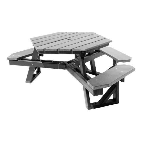 A hexagonal picnic table with attached benches, made of gray slatted material and supported by sturdy legs.