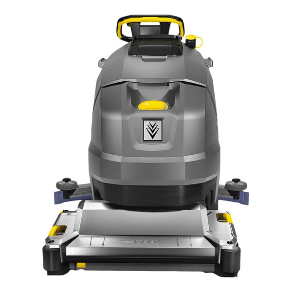 A large, gray and yellow walk-behind floor scrubber with cylindrical brushes and a sturdy handle, viewed from the front.