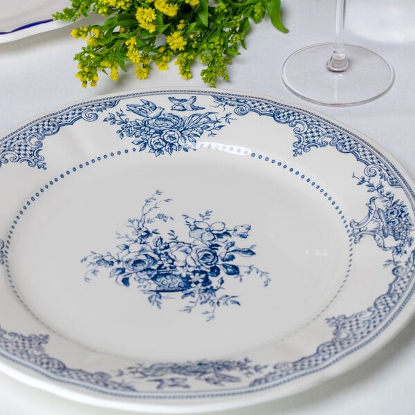 A round white plate with intricate blue floral patterns and decorative designs along the rim and center.
