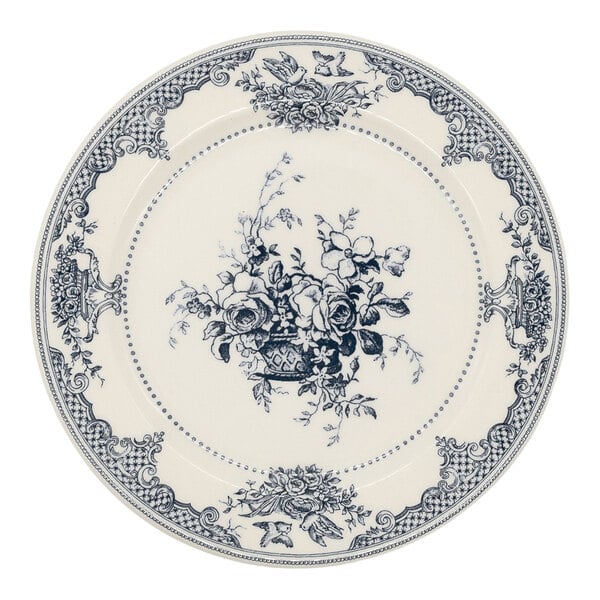 A round plate with an intricate black floral and decorative pattern on a white background, featuring a central bouquet design and ornate border details.