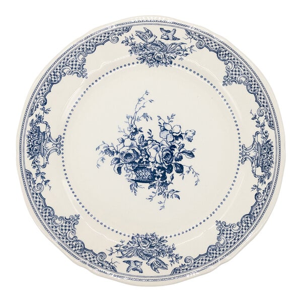 A round white plate with intricate blue floral and decorative patterns along the border and a central bouquet design.