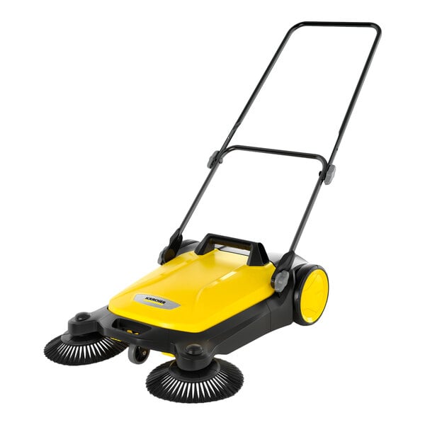 A yellow and black manual sweeper with two large front brushes, a handle, and two rear wheels.
