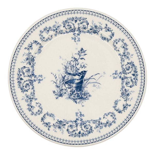 A round white plate with intricate blue floral patterns along the border and a central design featuring a bird perched on a branch.