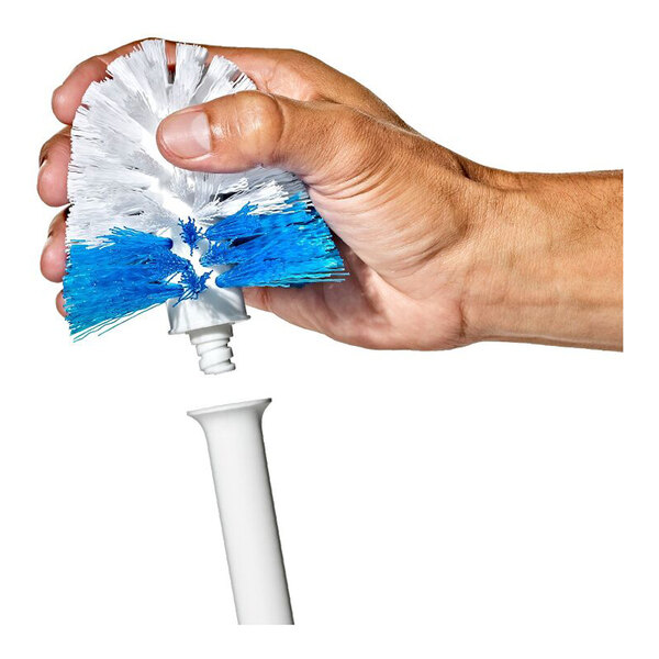 A hand is holding a white and blue brush head with a threaded end, positioned above a white handle, suggesting assembly or replacement.