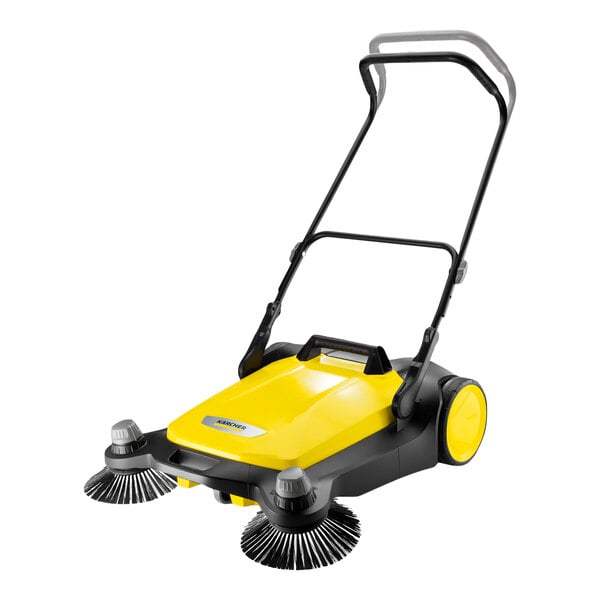 A yellow and black manual sweeper with two large side brushes, a handle, and wheels.