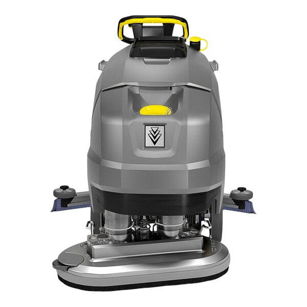 A gray and yellow walk-behind floor scrubber with visible cleaning brushes and control handles.