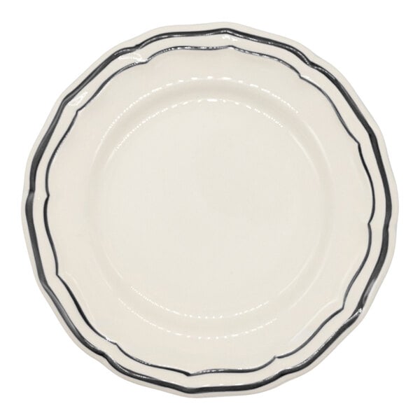A round, white plate with a scalloped edge and two thin black lines along the rim.