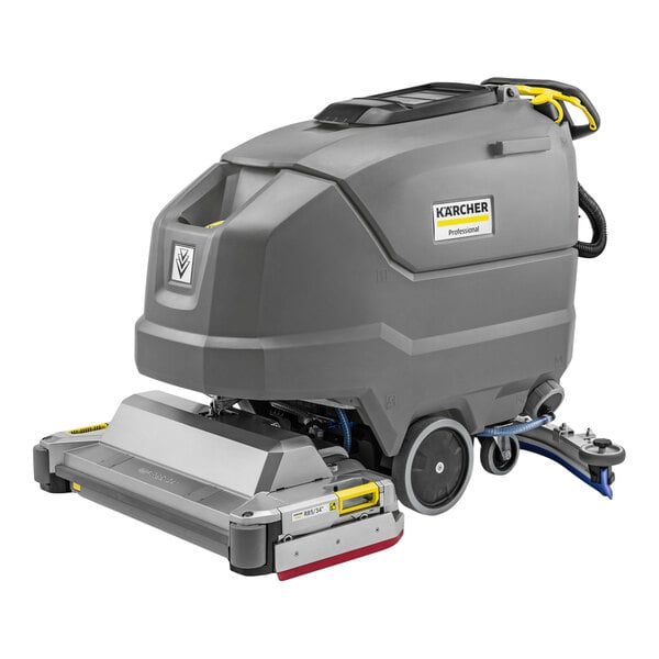 A large, gray, industrial floor scrubber with wheels, a handle, and visible control panel, labeled with the Karcher brand.
