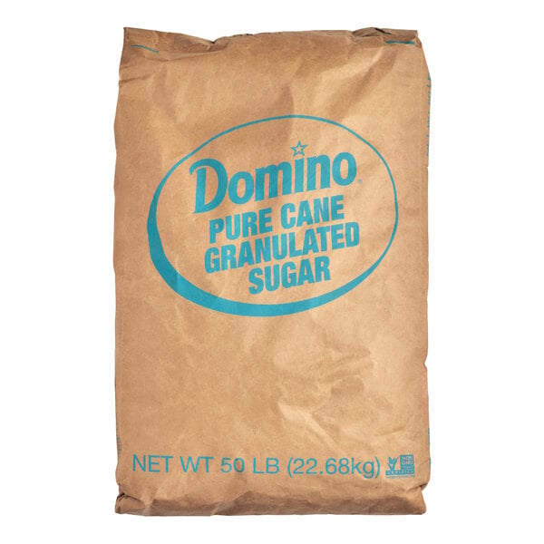 A large brown paper bag labeled 'Domino Pure Cane Granulated Sugar' with a net weight of 50 lb (22.68 kg).