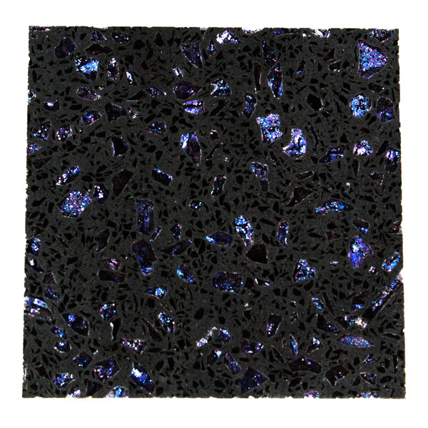 A close-up view of a black surface with embedded, irregularly shaped blue and purple reflective fragments.