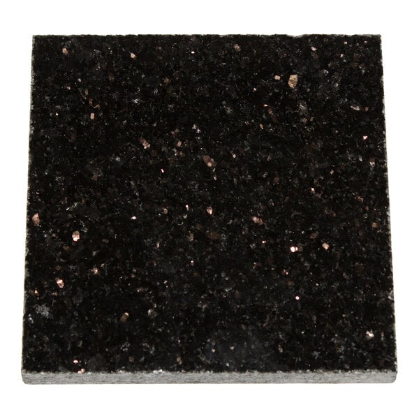 A close-up of a square, black, granite-like surface with reflective specks.