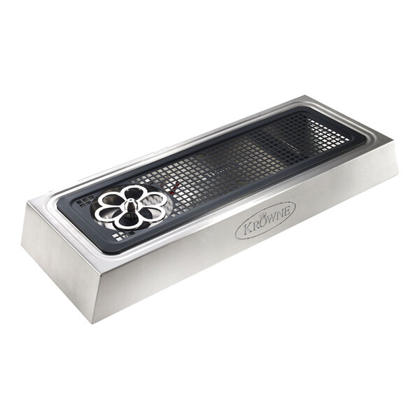 A rectangular stainless steel device with a black grid surface, a circular metal component on one end, and the brand name 'Krowne' visible on the side.