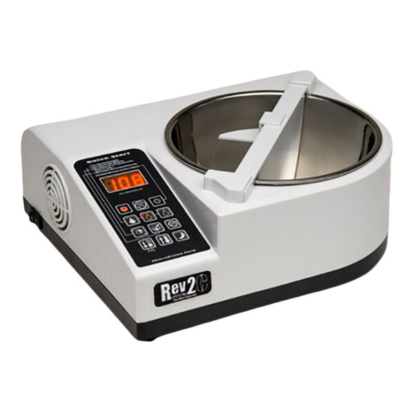 A white electronic device with a digital control panel and a stainless steel bowl, likely used for food preparation.