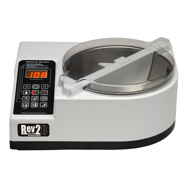 A white electronic device with a digital display, control panel, and a round transparent lid on top.